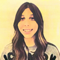 Illustration of a smiling person with long brown hair and wearing a gray shirt with black text on it against a light background.